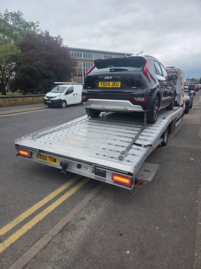 Black Kia Sportage SUV on Tow 2 Tow recovery truck flatbed