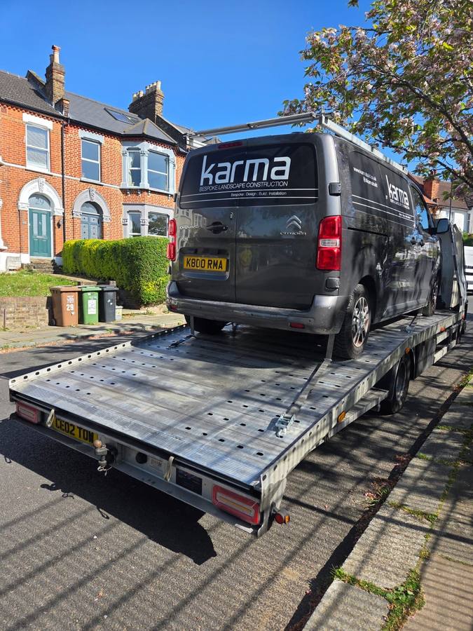 Black Karma Konstrukta commercial van recovered on truck flatbed