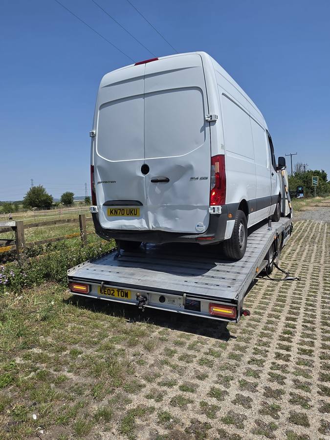 White Mercedes van on Tow 2 Tow flatbed in rural countryside setting